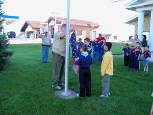 The Cub Scouts raise the flag